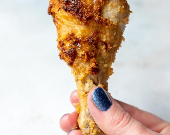 hand holding crispy keto air fryer chicken drumstick