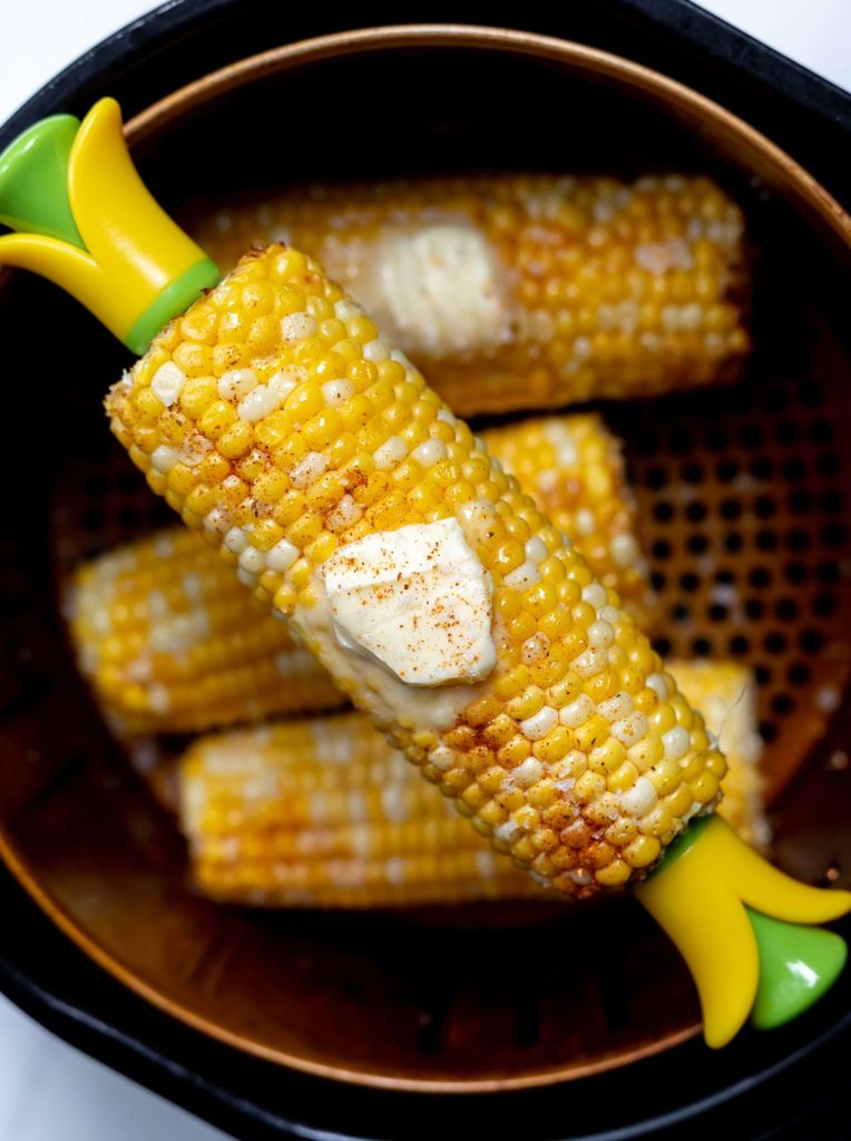 buttered, spiced corn cob on skewers