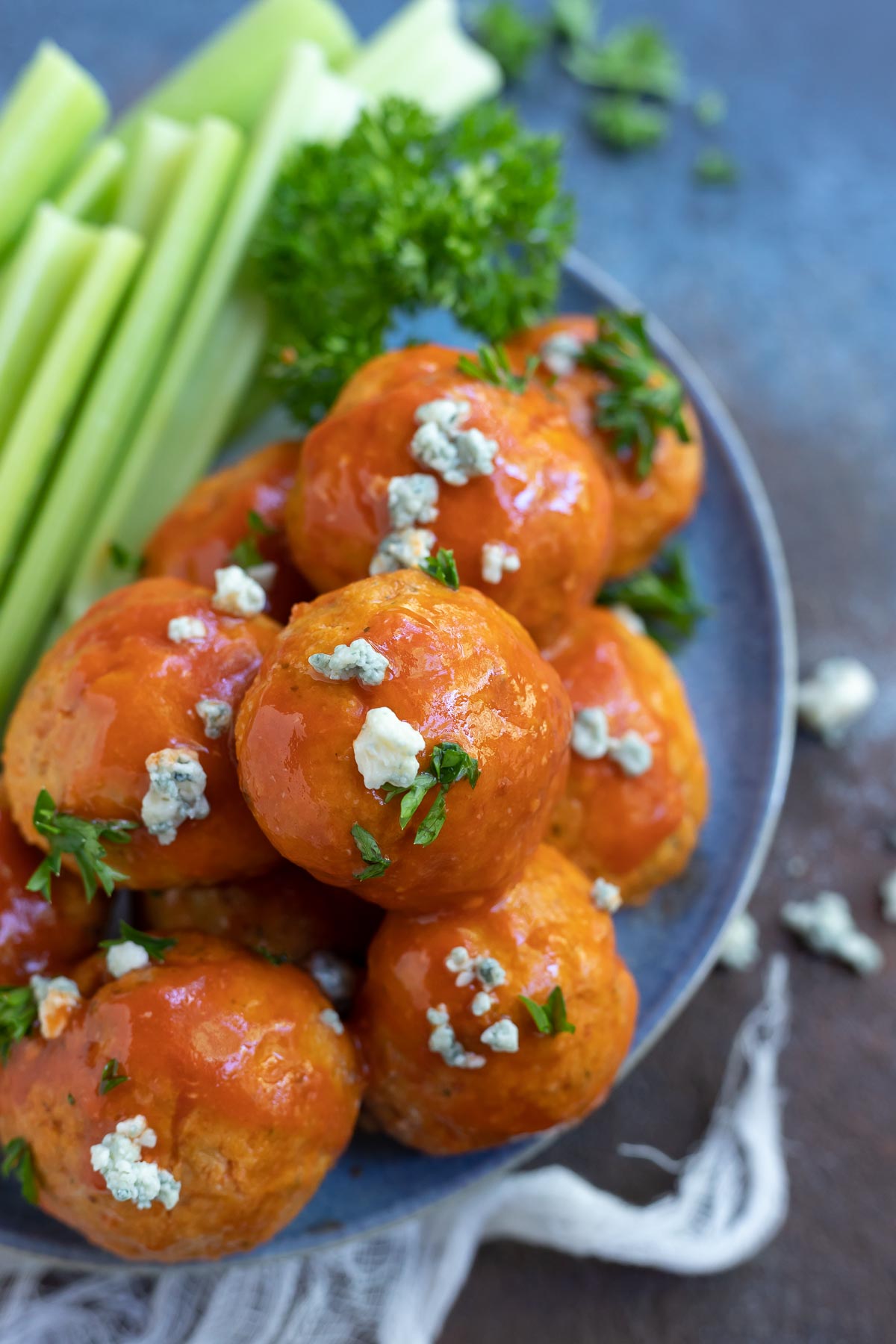 bright red buffalo meatballs topped with blue cheese and parsley