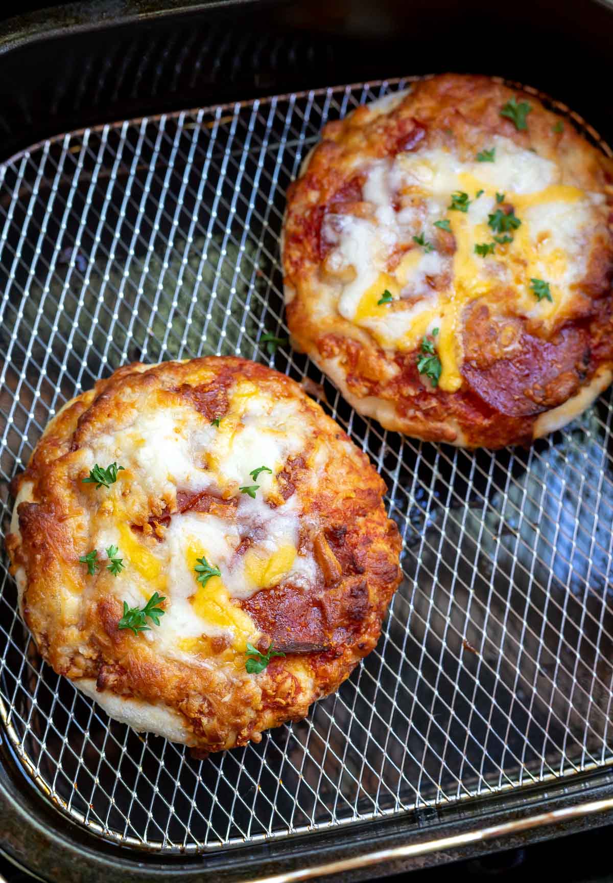 cooked pizzas in air fryer basket