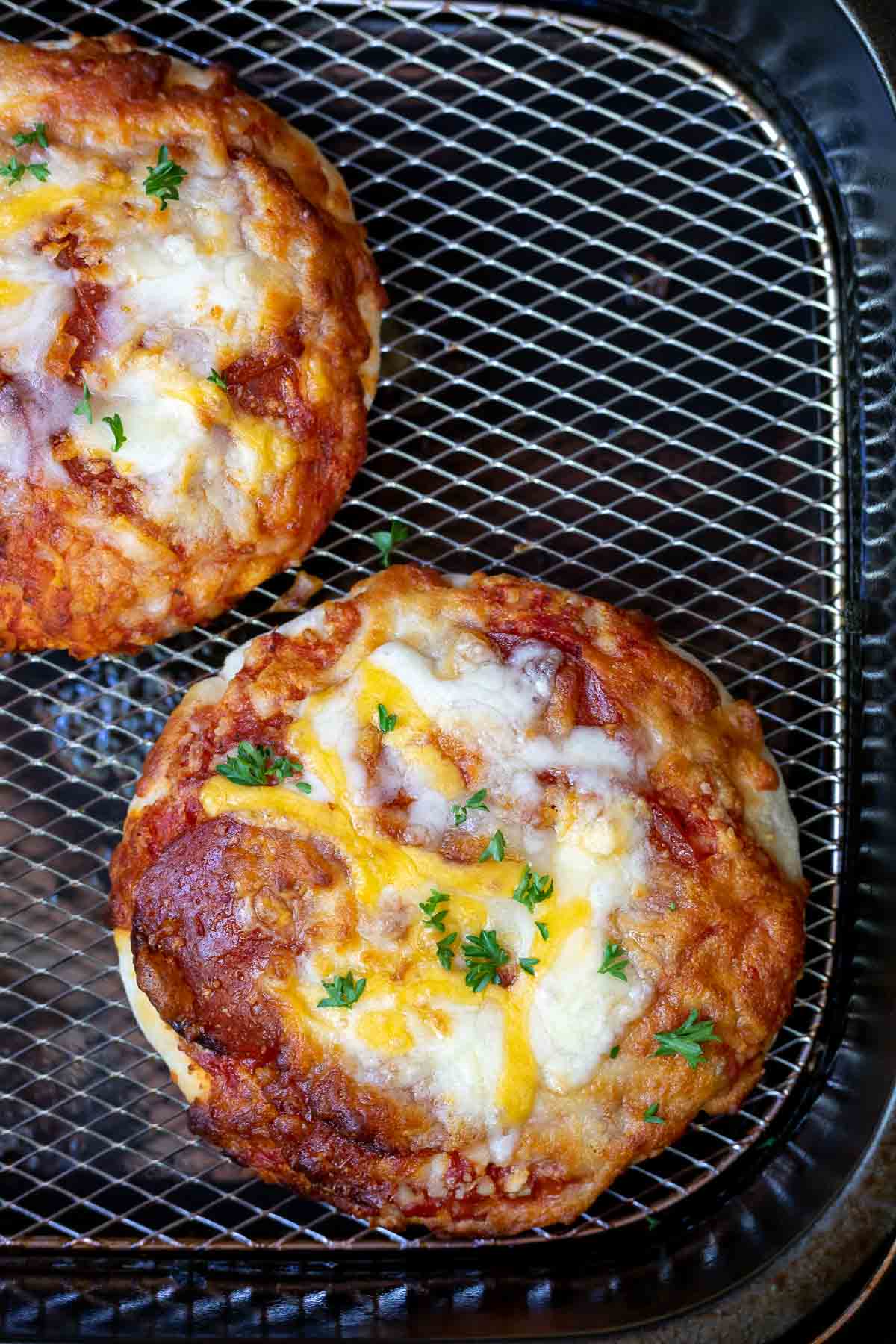 cooked mini pizzas in air fryer basket