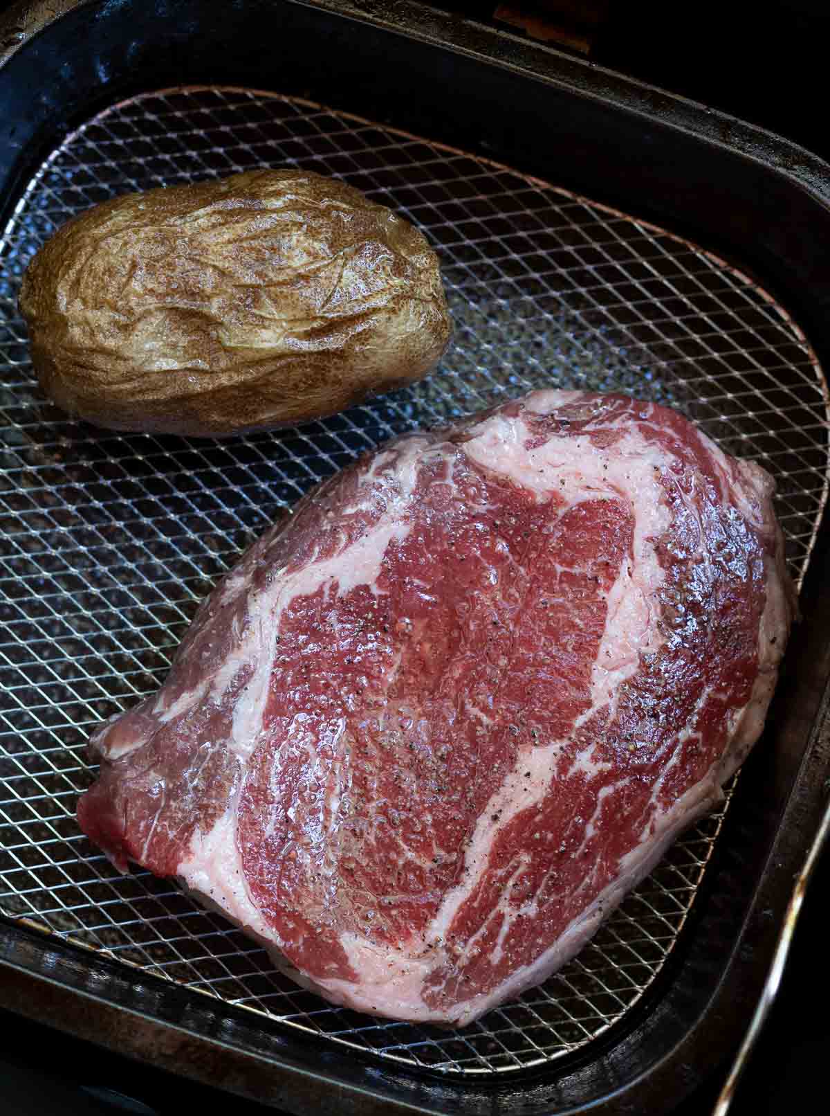 raw steak in air fryer basket