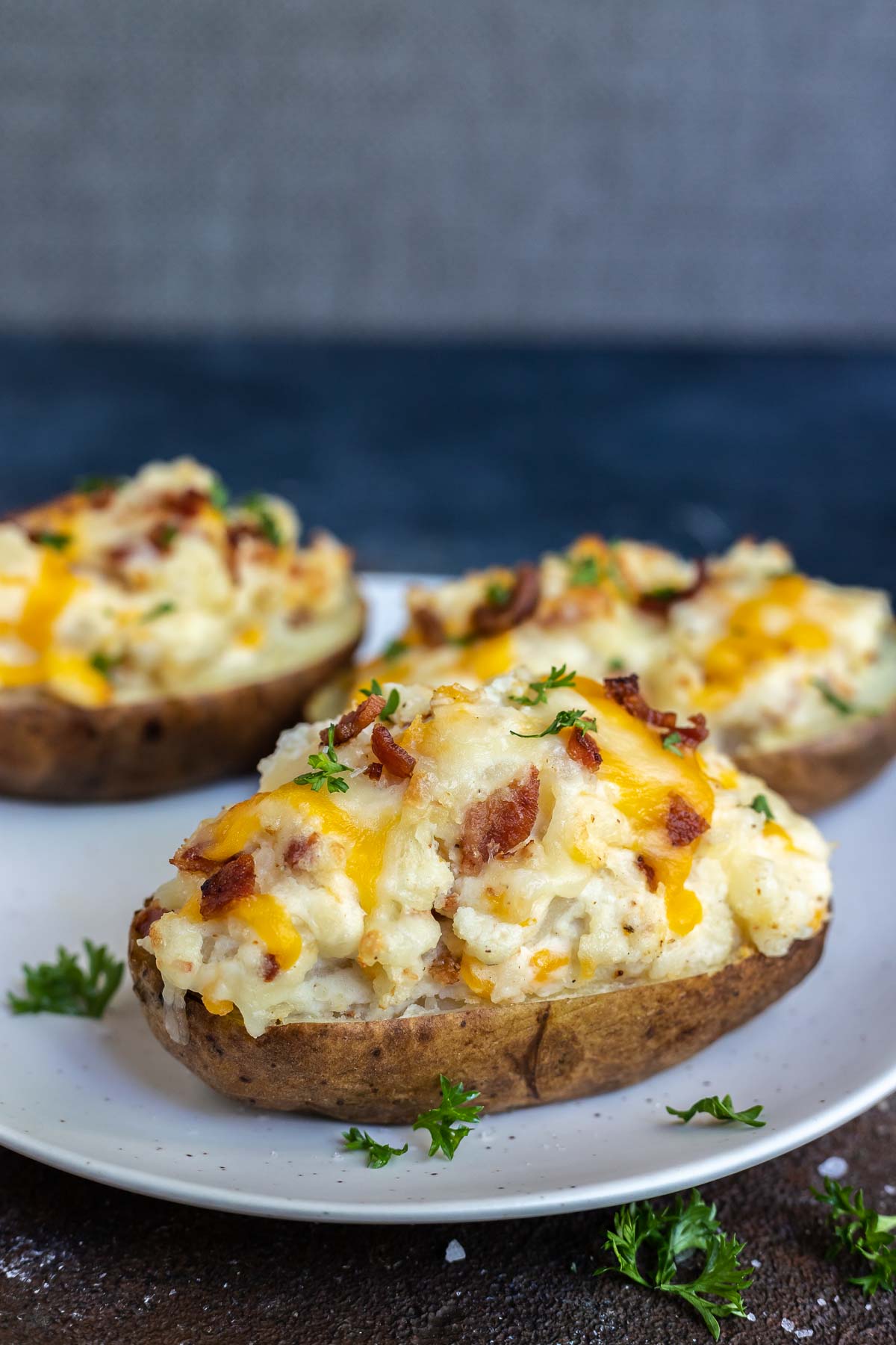 bacon and cheese twice baked potatoes on white plate