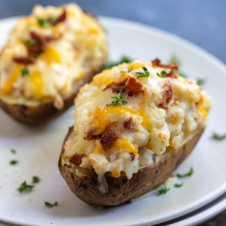 twice baked potatoes topped with melted cheese and bacon bits