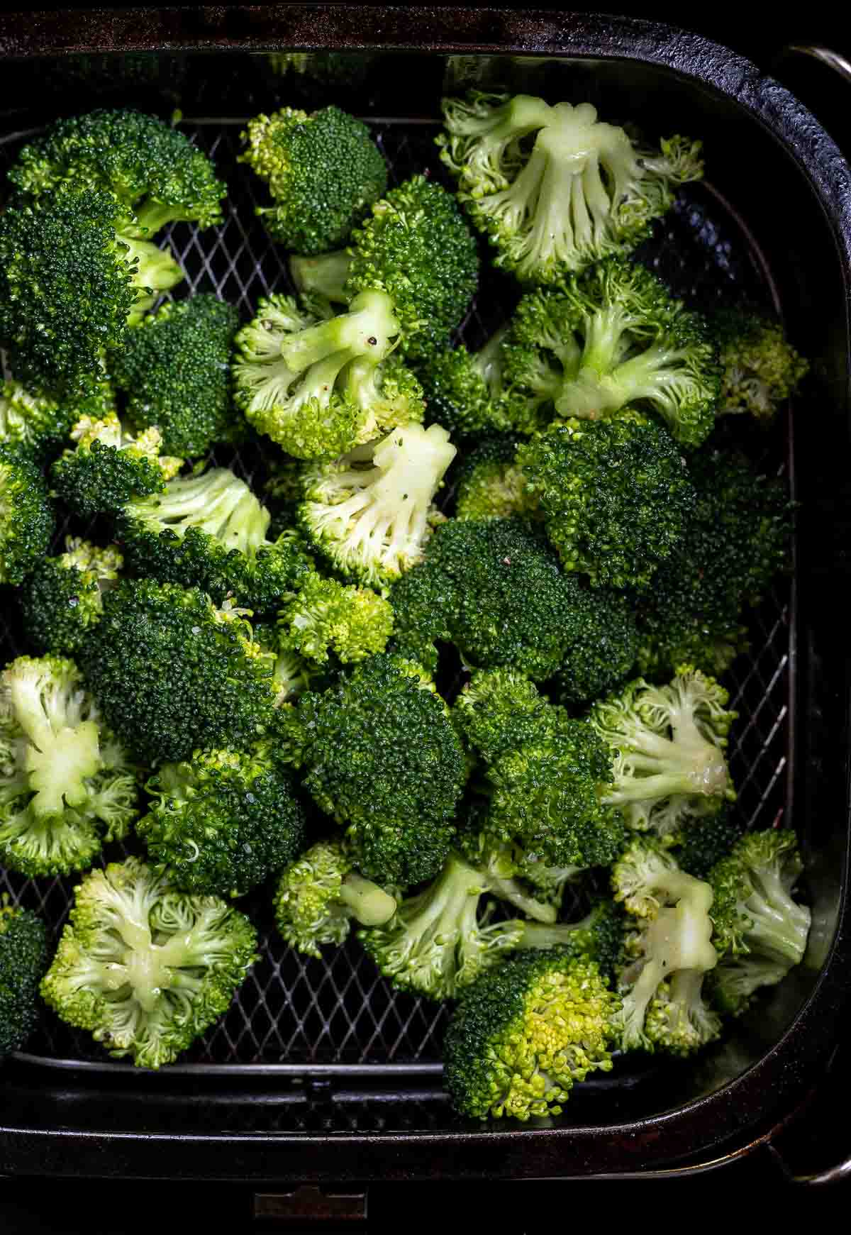 raw broccoli in air fryer basket