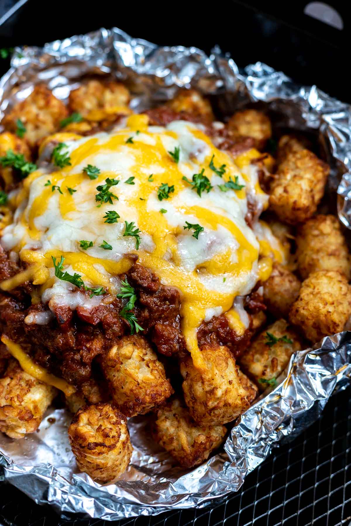 tater tots topped with chili and melted cheese