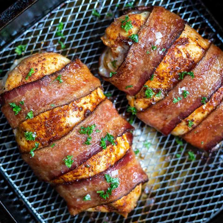 cooked chicken breast with bacon in air fryer basket