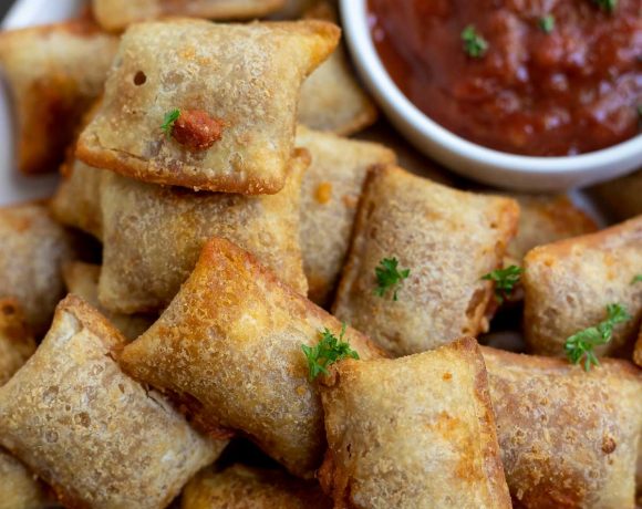 golden brown air fried pizza rolls served with marinara sauce