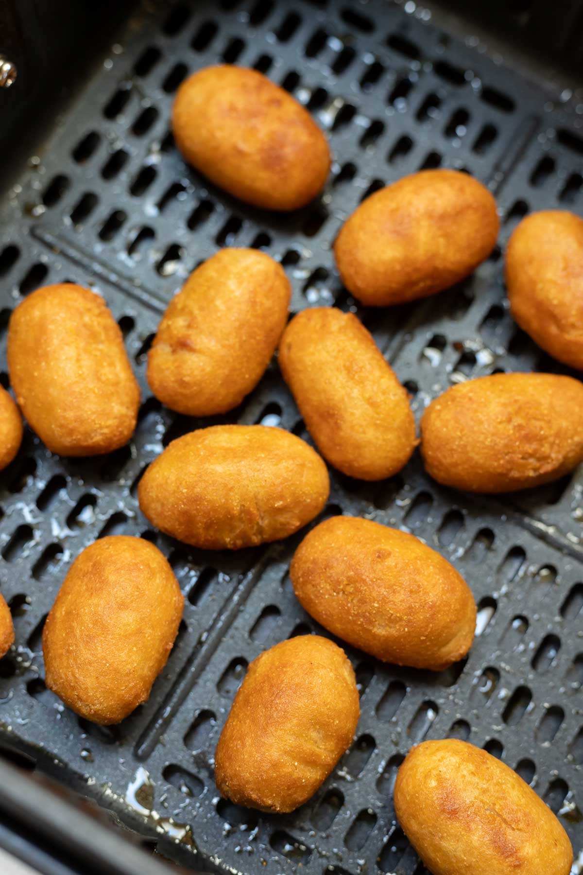 cooked mini corndogs in air fryer basket