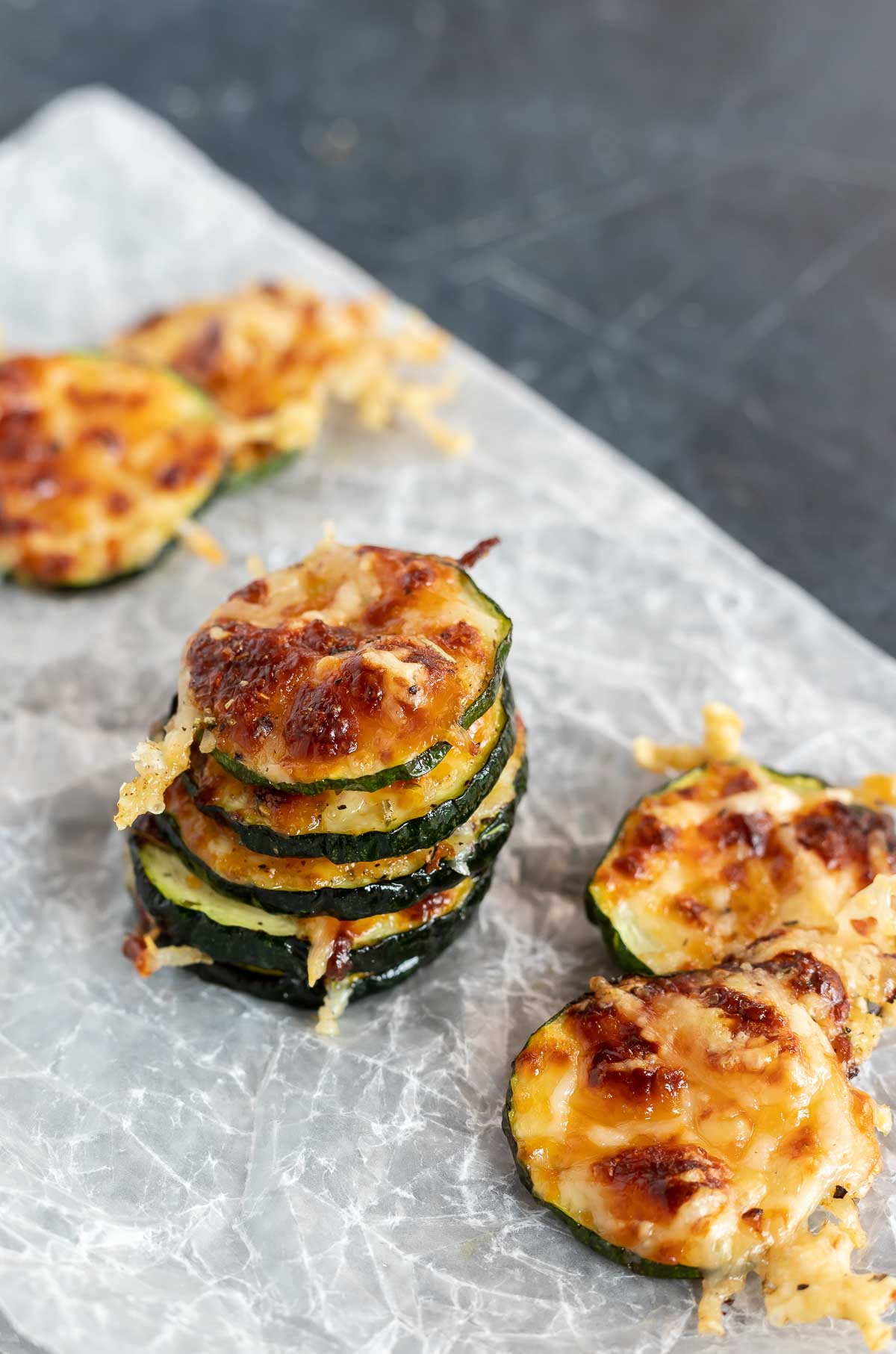 stacks of air fried zucchini chips on wax paper