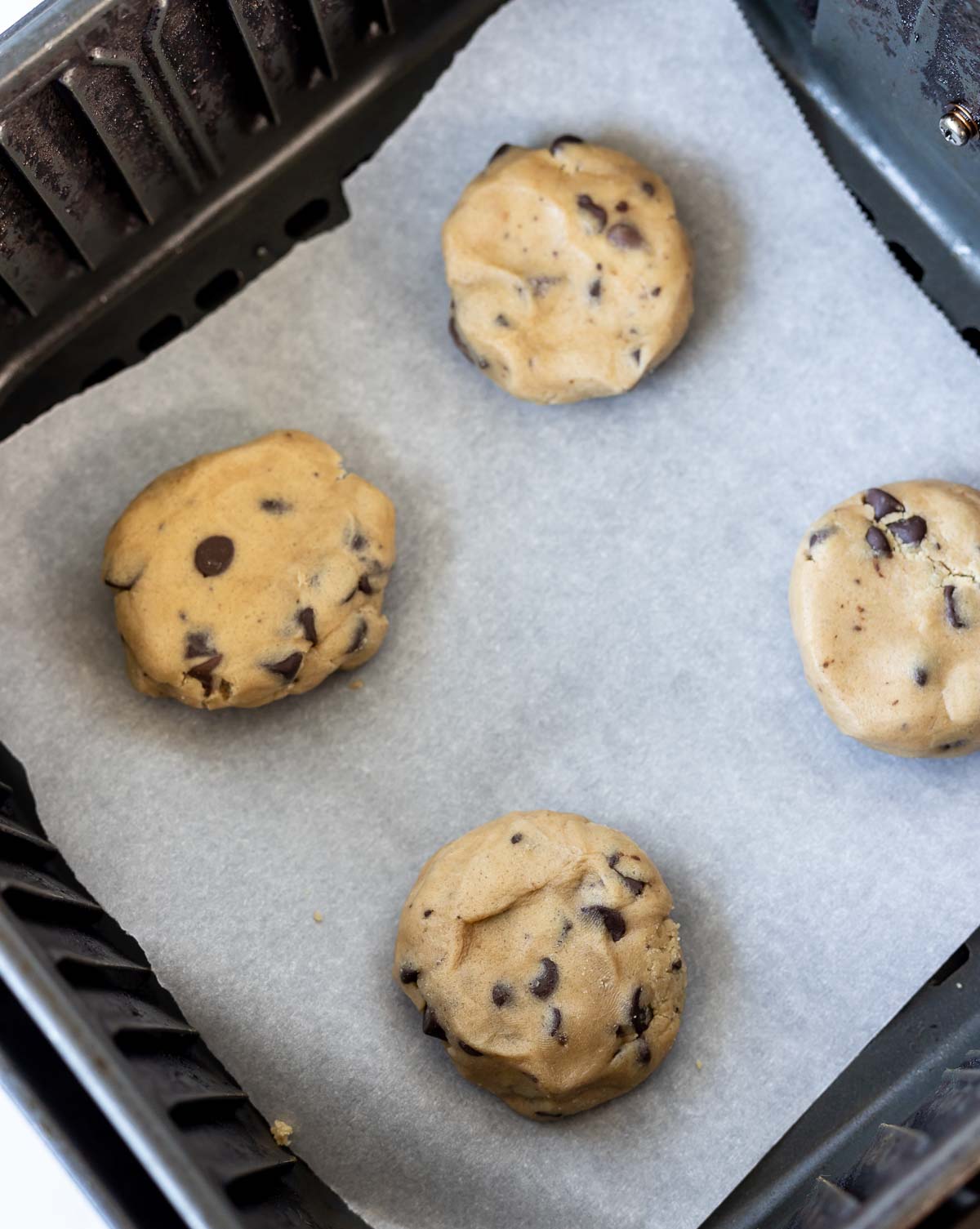 unbaked cookie dough balls in air fryer basket