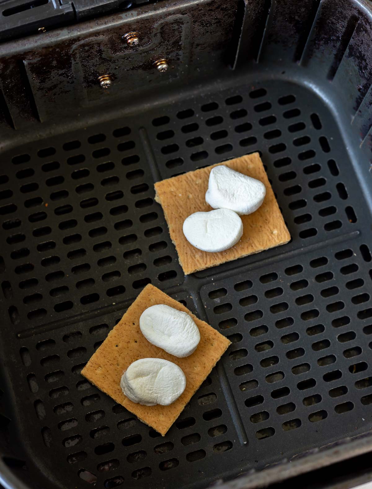 graham crackers topped with marshmallows in air fryer basket