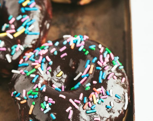 chocolate glazed donuts topped with colorful sprinkles