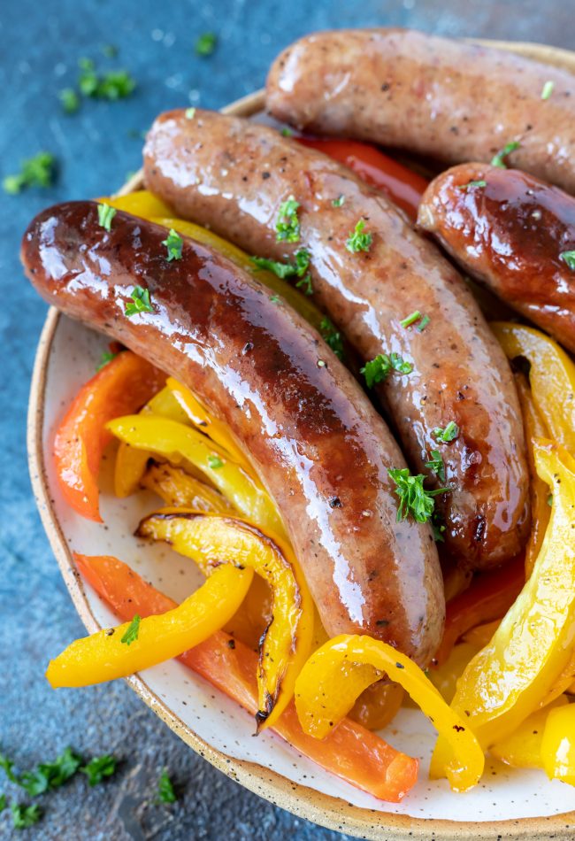 brats and peppers in white dish