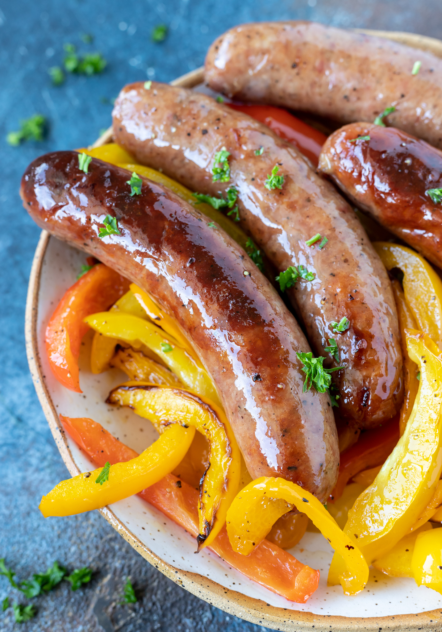 brats and peppers in white dish