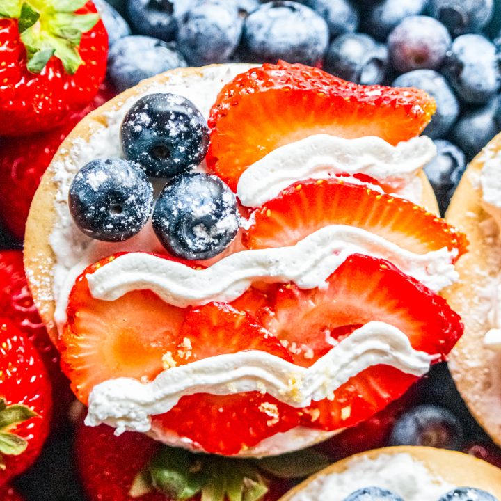 cookie decorated with strawberries blueberries and cream